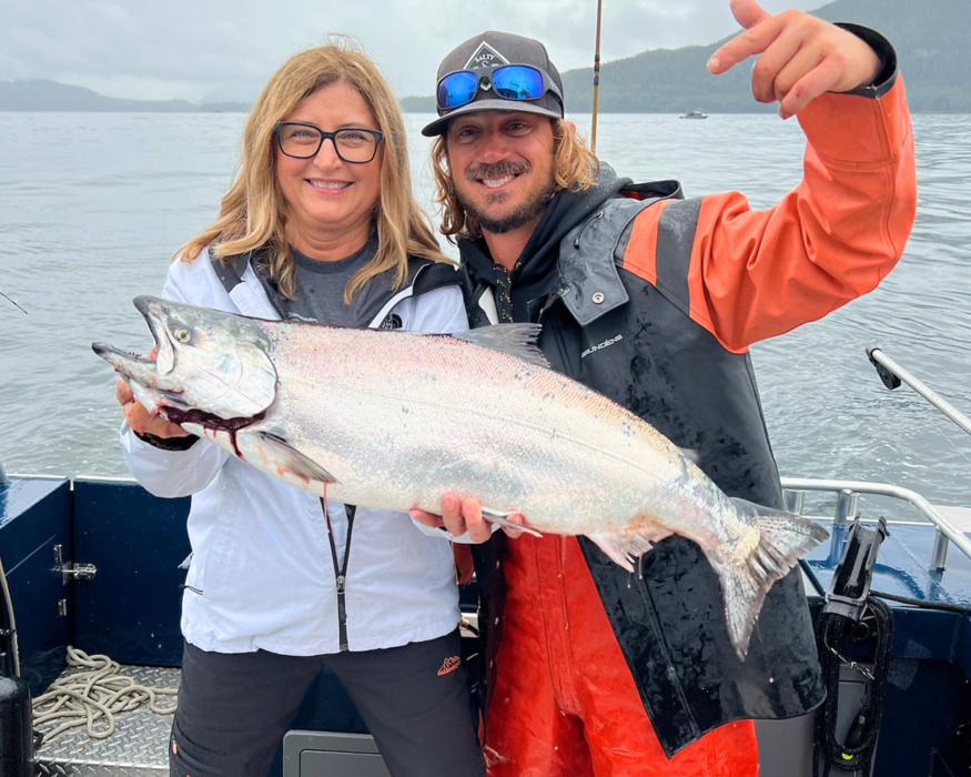 Captain Lukas, ketchikan fishing guide, and a woman holding a massive salmon