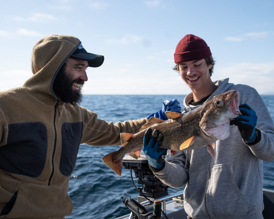 Captain grayson, a ketchikan fishing guide, and a gust holding a cod