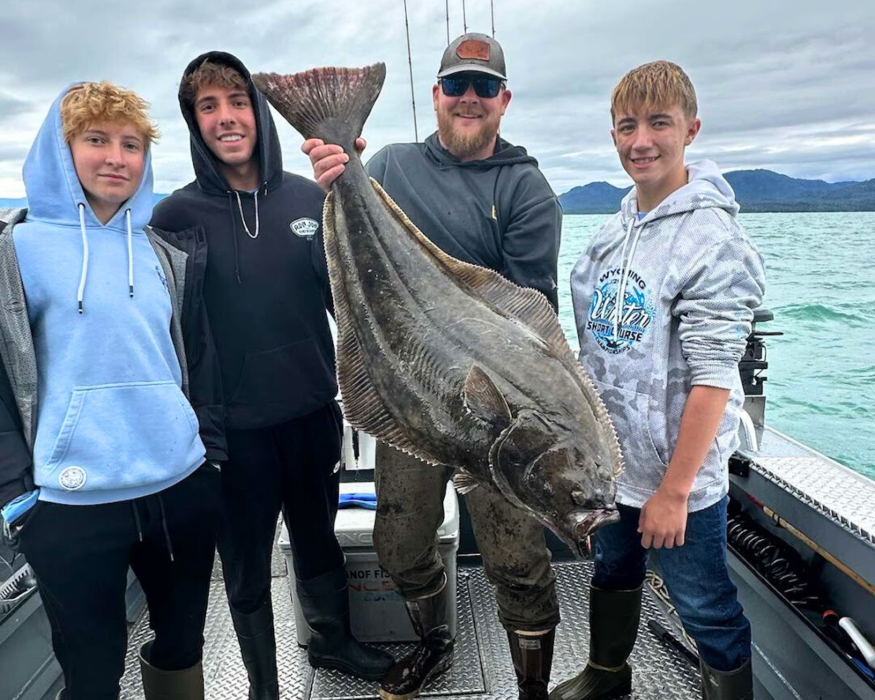 Captain Tony, a ketchikan fishing guide, holding a huge pacific halibut