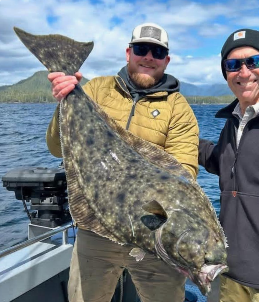 Captain Tony of Ketchikan's Finest Fishing Charters holding a massive pacific halibut.