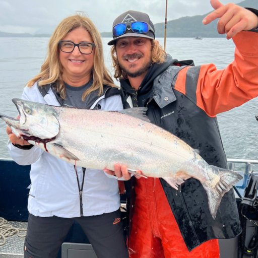 Captain Lukas, ketchikan fishing guide, and a woman holding a massive salmon