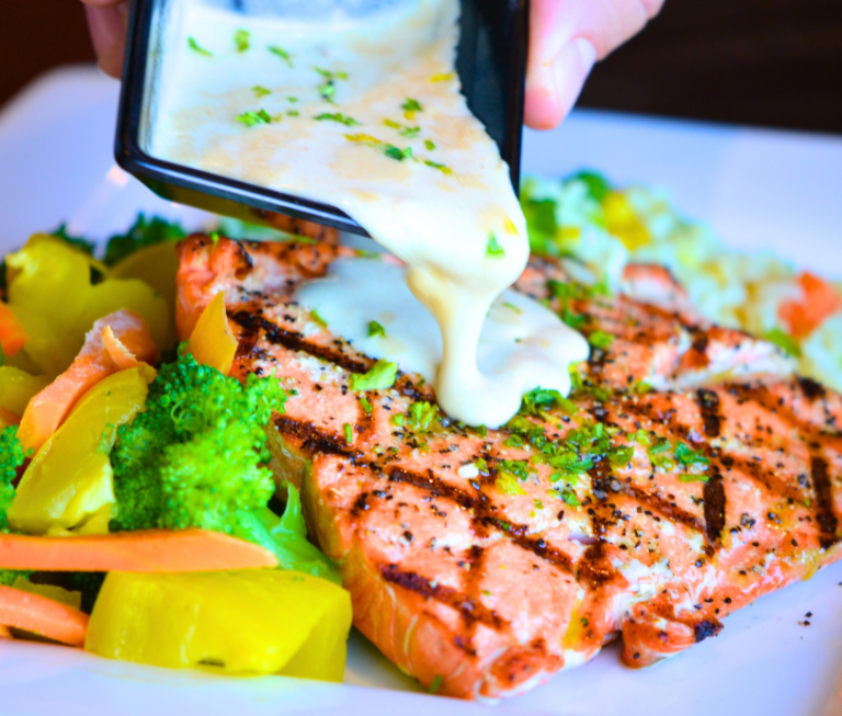 Freshly grilled alaskan salmon with a cream sauce.