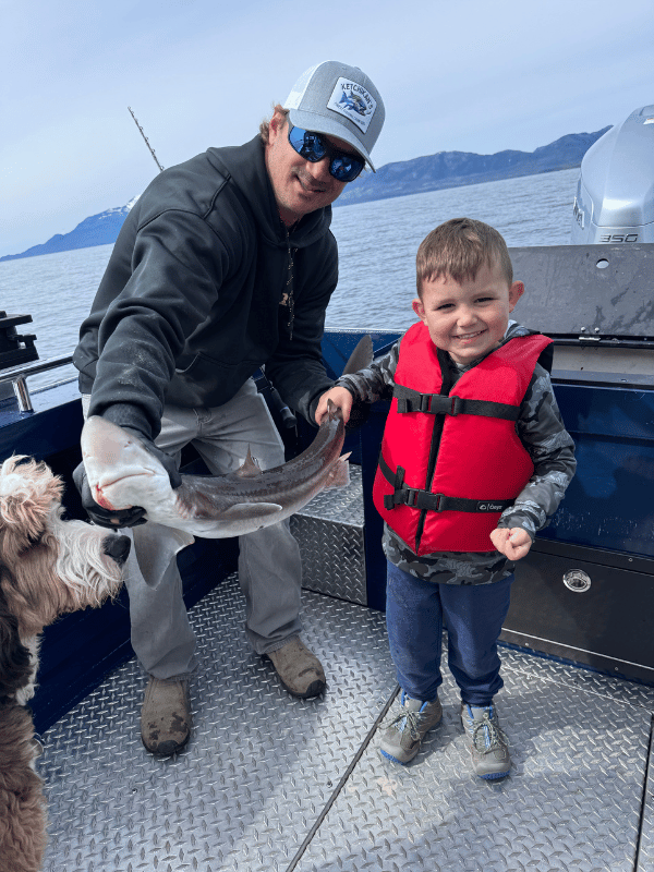 Captain Lukas of Ketchikan's Finest Fishing Charters holding a small shark